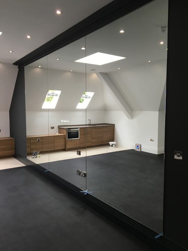 Frameless glass partition in loft conversion by South Lambeth glaziers