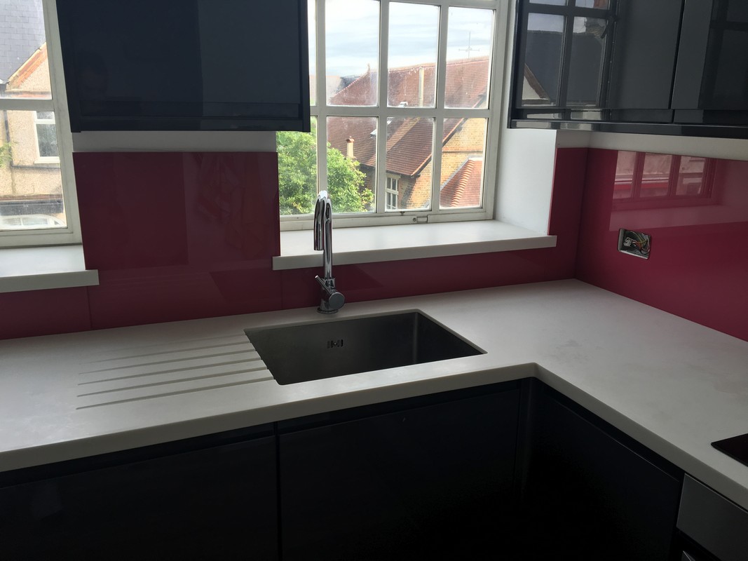 Deep plum coloured glass splashback in modern South Lambeth kitchen
